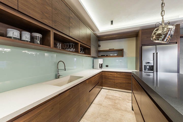 The kitchen features sleek, dark wood cabinetry that adds warmth and elegance to the space. 