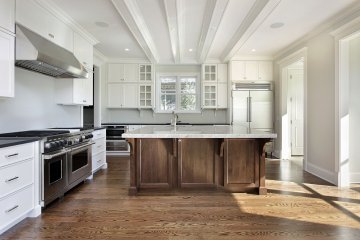 1. The kitchen features a large central island with a marble...