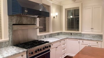 1. The kitchen features a large stainless steel gas range wi...