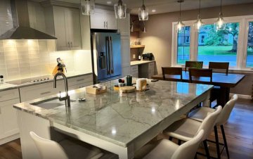 "Polished marble countertops exude elegance, providing a stu...