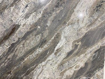 "These stunning quartzite countertops showcase a mesmerizing...