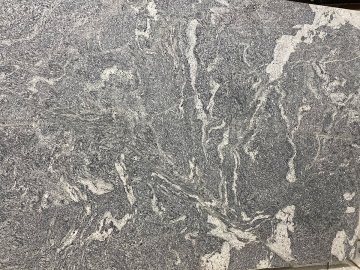 "Richly textured with swirling patterns, this granite counte...